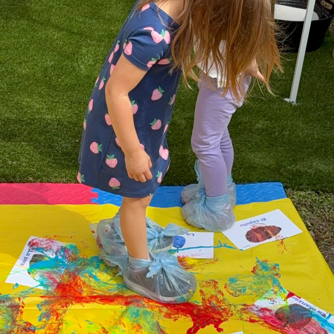 Children learning Spanish through a colorful painting activity